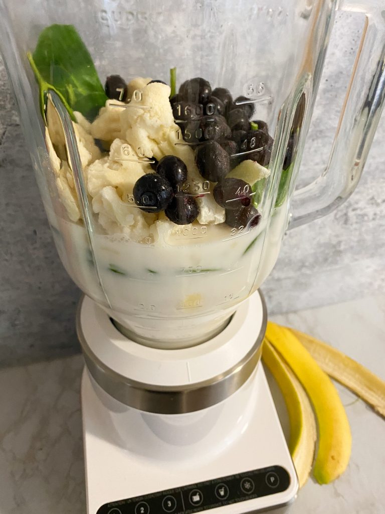 ingredients for blueberry smoothie in a blender