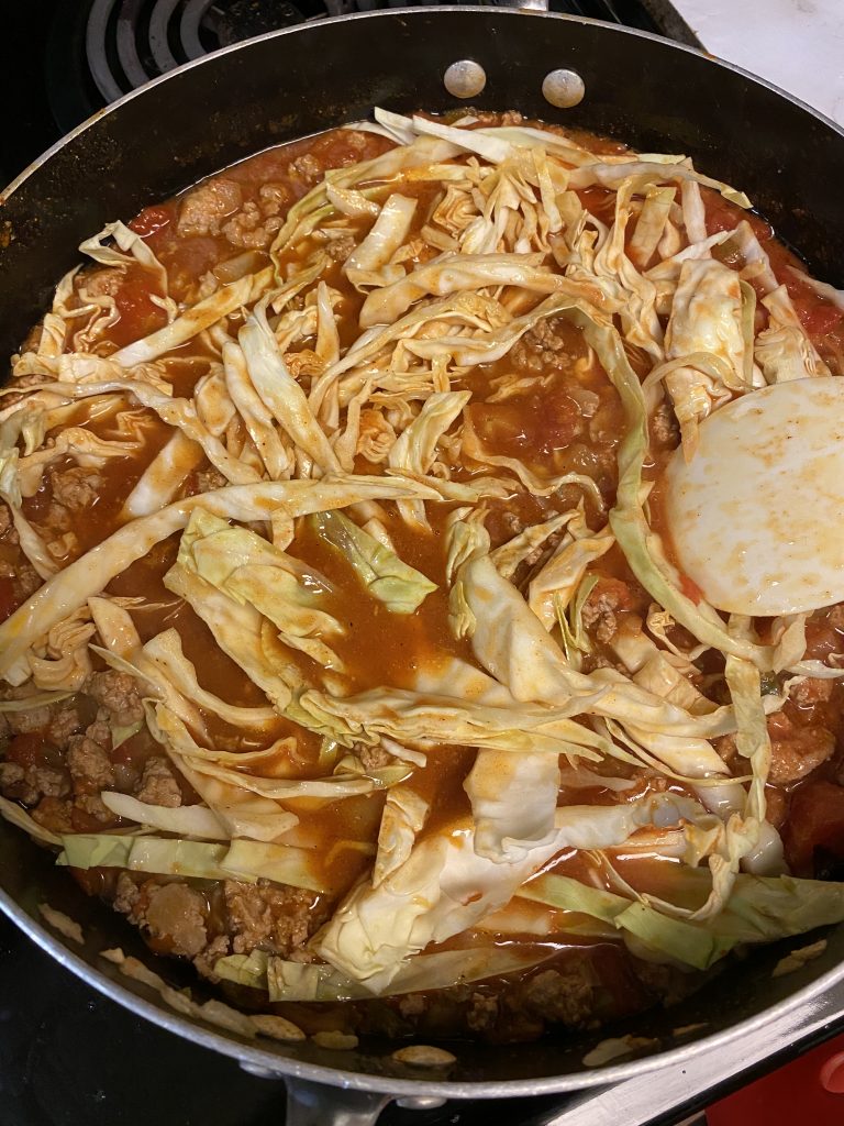 adding cabbage to mexican soup to cook