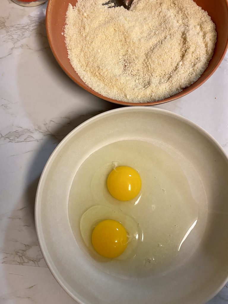 eggs and parmesan in shallow bowls 