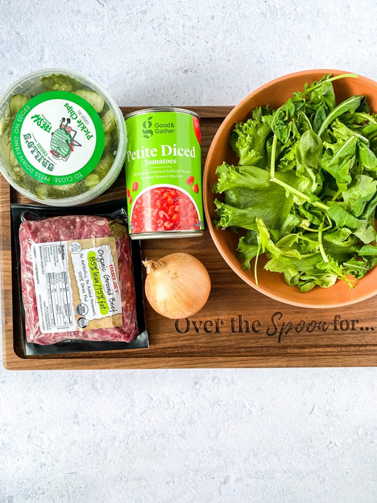 ingredients for a bunless burger on a wooden platter