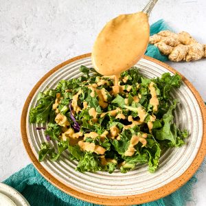 drizzling dressing on salad