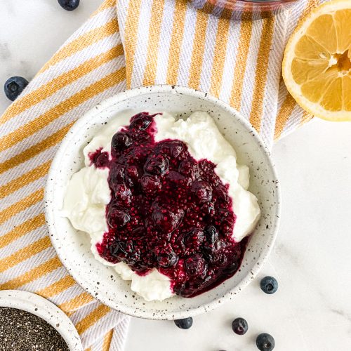 a bowl of yogurt with chia seed jam and a lemon