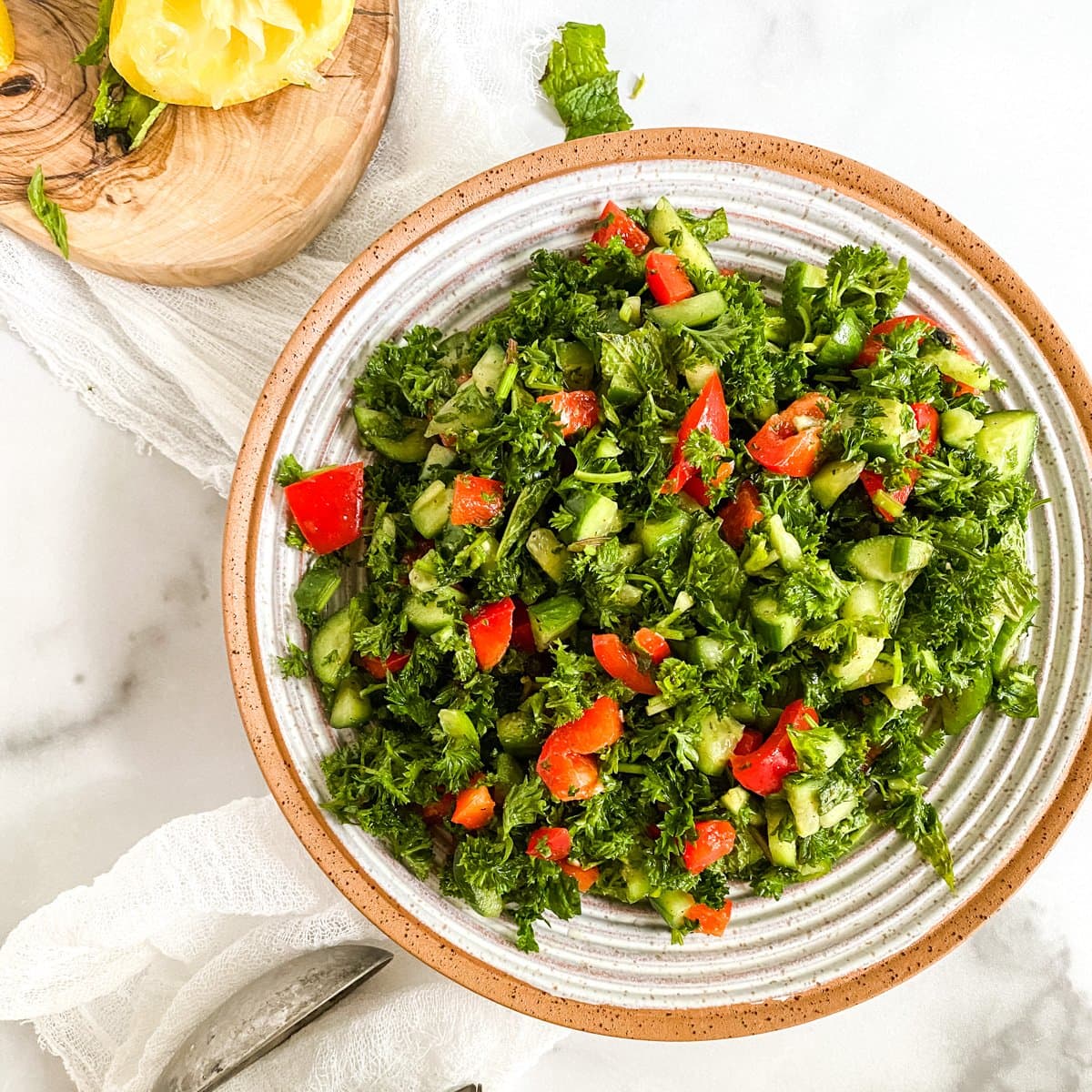 tabouli in a bowl with lemon on the side