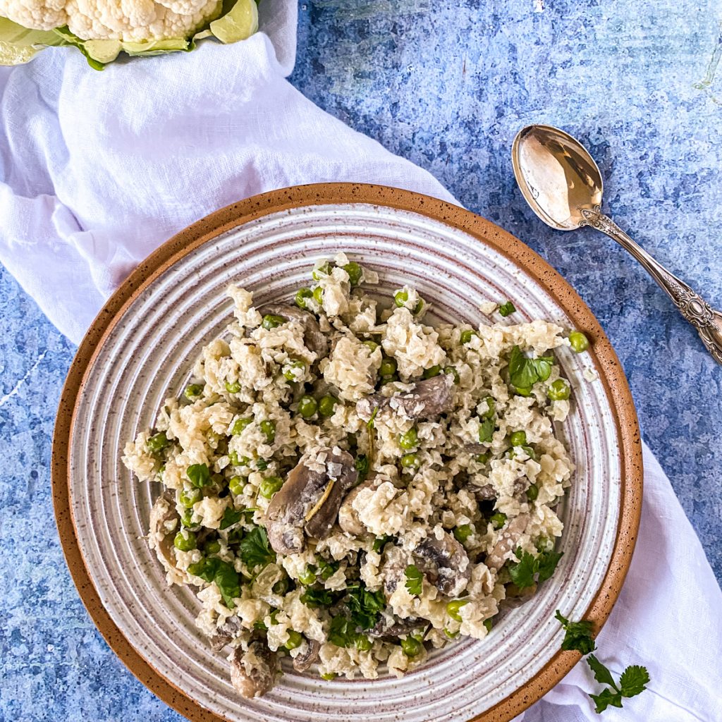 a bowl of risotto with mushrooms on a blue background