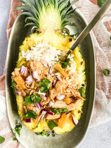 chicken and rice served in a pineapple