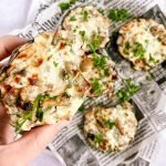 a close up of holding one stuffed mushroom