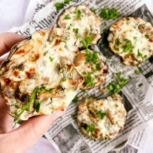 a close up of holding one stuffed mushroom