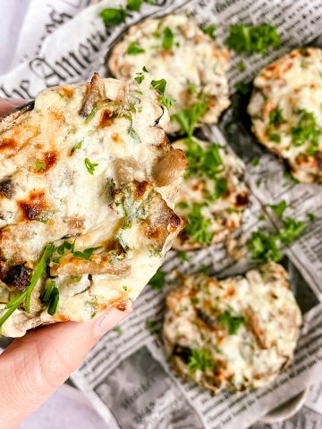 a close up of holding one stuffed mushroom