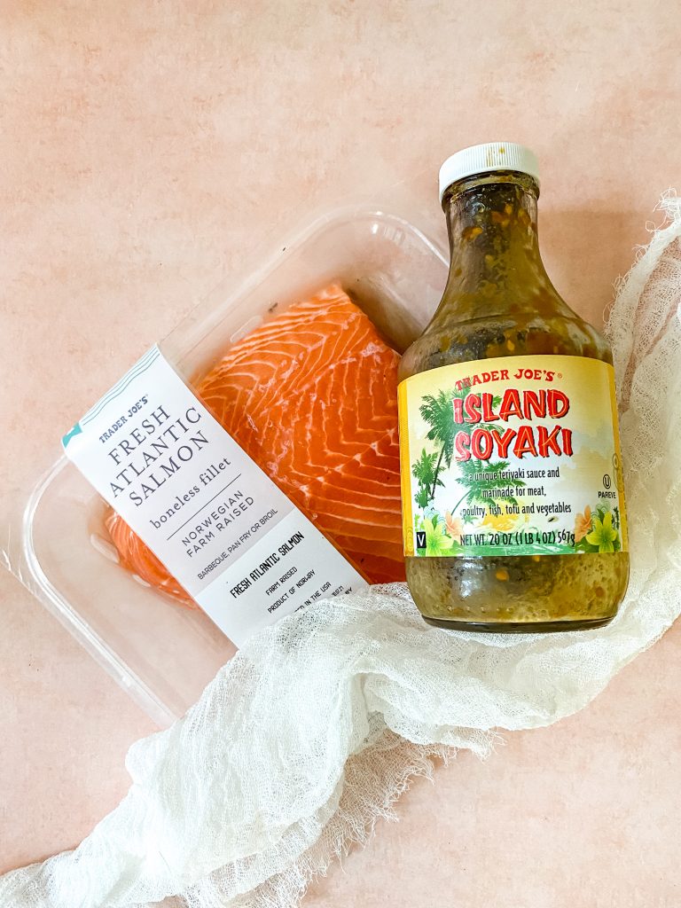 salmon and teriyaki sauce on a pink background 