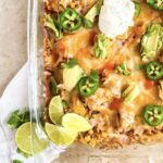 chicken fajita casserole topped with sour cream and jalepeno