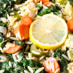 A close up of orzo, carrots, kale, celery and lemon
