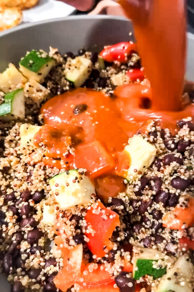 a bowl of enchilda sauce being poured into pan