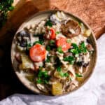 a bowl of dairy free chicken and wild rice soup on a white napkin