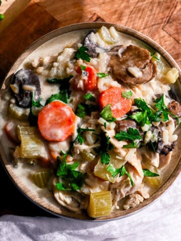 a bowl of dairy free chicken and wild rice soup on a white napkin