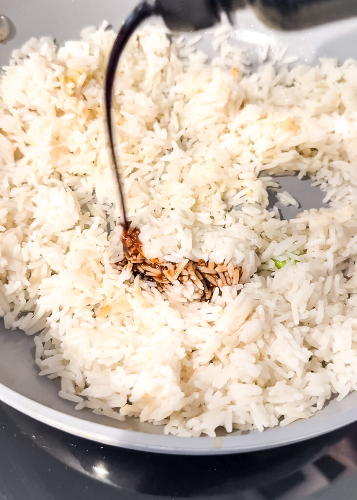 pouring soy sauce over rice