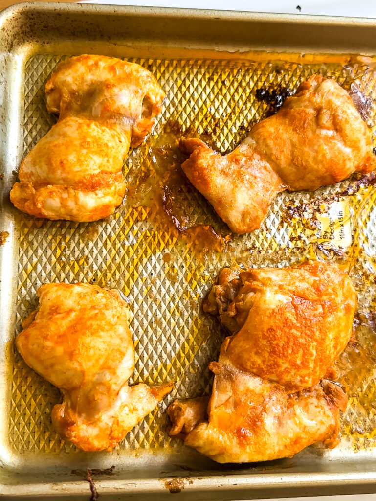Baked buffalo chicken thighs on a sheet pan