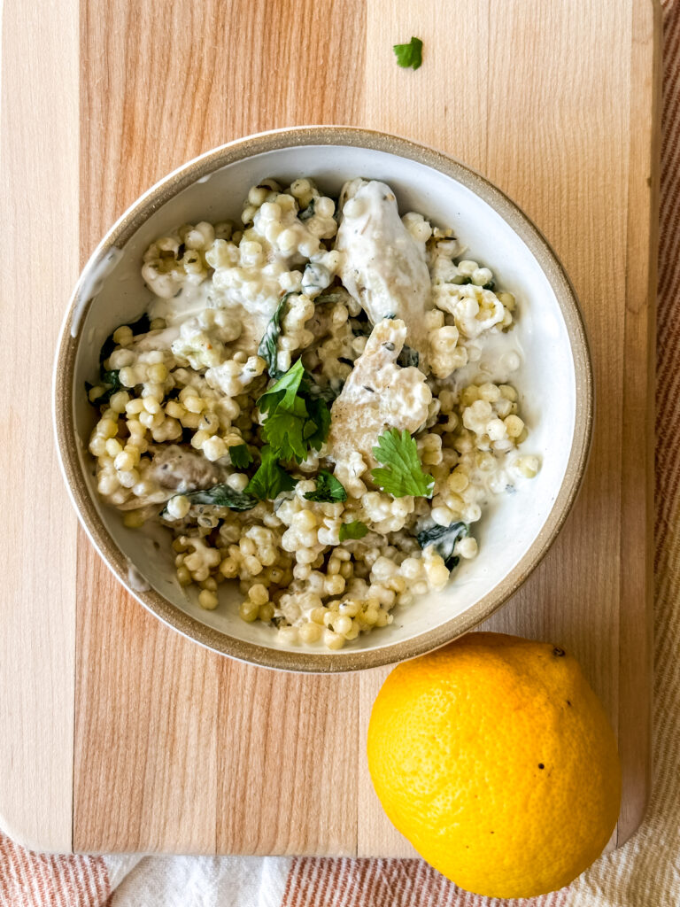 Bowl of Lemon Chicken Couscous on wood cutting board