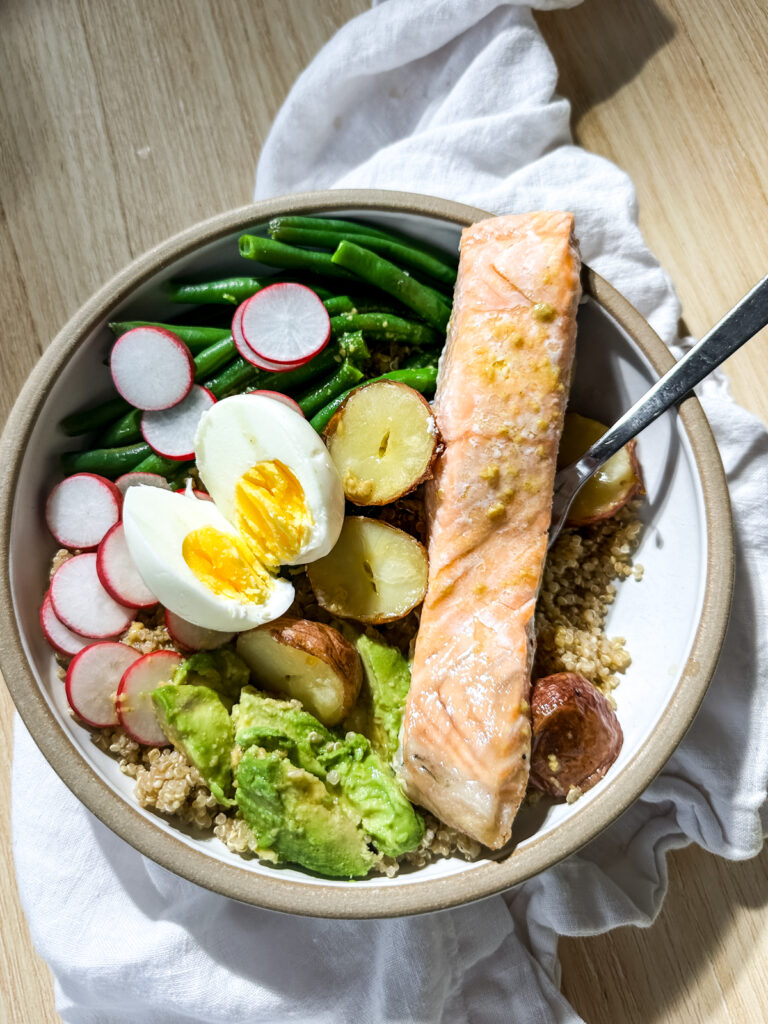 a healthy salmon quinoa salad in a big bowl