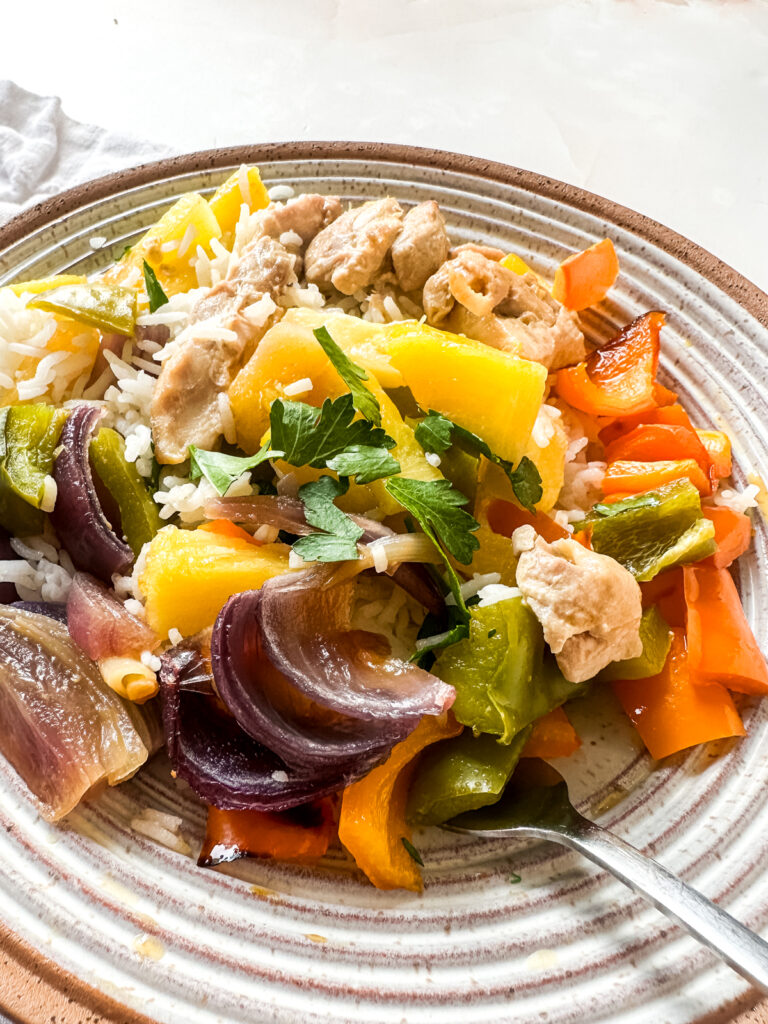 Hawaiian Sheetpan Chicken in a bowl with a cilantro garnish